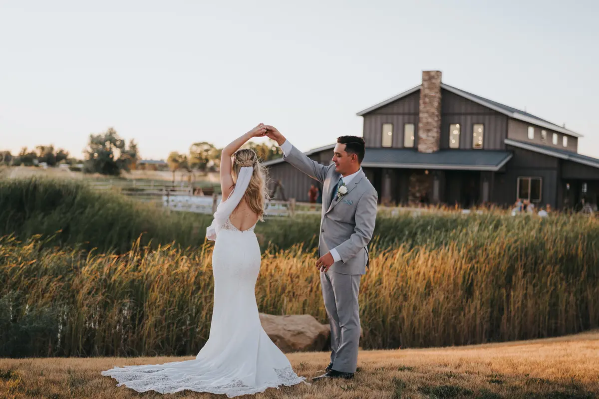 Bride and groom dancing outdoors at golden hour
