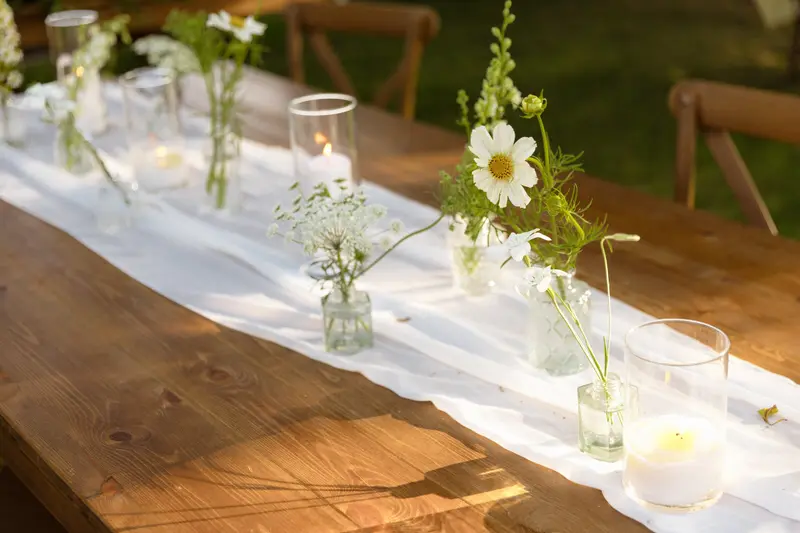 Wedding reception table with candles and wildflowers